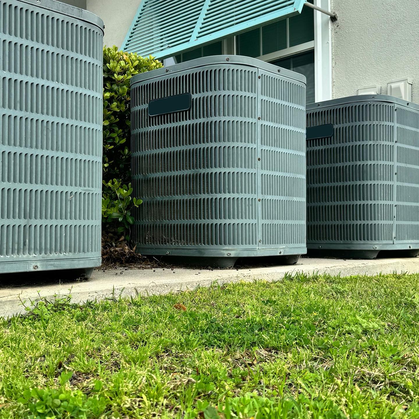 Row of residential AC condenser units serviced by Heat and Air Rescue in Cooke, Grayson & Denton Counties